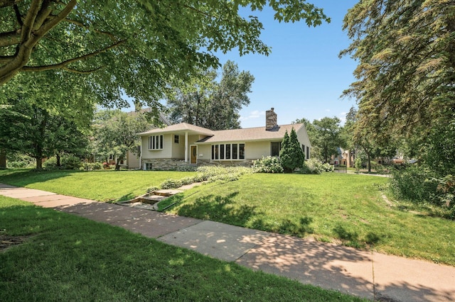 1281 Minnehaha Pkwy, Minneapolis, MN 55419 - tri-level home featuring stone siding, a chimney, and a front lawn
