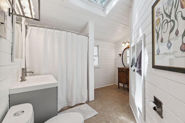 4356 Nokomis Ave, Minneapolis, MN 55406 - bathroom featuring a skylight, vanity, a shower with shower curtain, and tile patterned floors