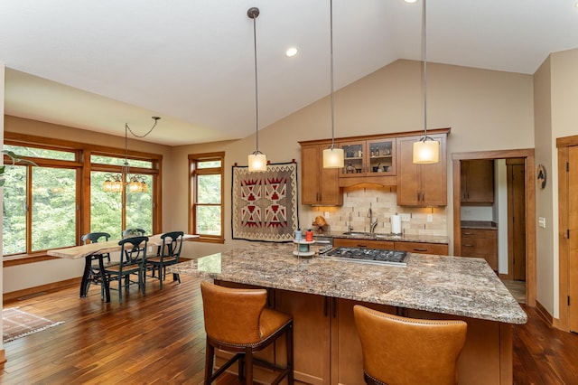 4089 Stone Point Dr NE, Rochester, MN 55906 - kitchen featuring brown cabinetry, lofted ceiling, stainless steel gas stovetop, dark wood-style floors, and healthy amount of natural light