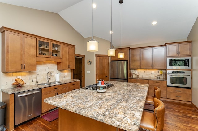 4089 Stone Point Dr NE, Rochester, MN 55906 - kitchen with stainless steel appliances, vaulted ceiling, dark wood-type flooring, tasteful backsplash, and light stone counters