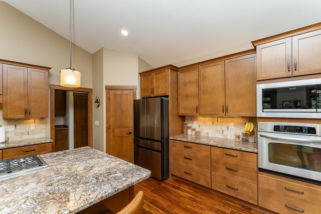 4089 Stone Point Dr NE, Rochester, MN 55906 - kitchen featuring appliances with stainless steel finishes, lofted ceiling, dark wood-type flooring, tasteful backsplash, and brown cabinetry