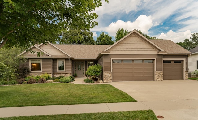 4089 Stone Point Dr NE, Rochester, MN 55906 - view of front facade with an attached garage, stone siding, concrete driveway, a front lawn, and a shingled roof