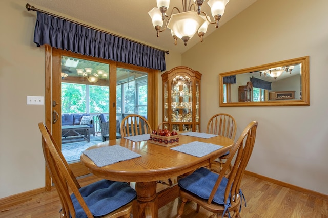 5551 Nancy Ln NW, Rochester, MN 55901 - dining space featuring a chandelier, light wood finished floors, and vaulted ceiling