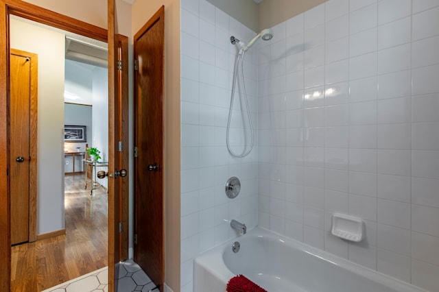 5551 Nancy Ln NW, Rochester, MN 55901 - bathroom featuring shower / bathtub combination and wood finished floors