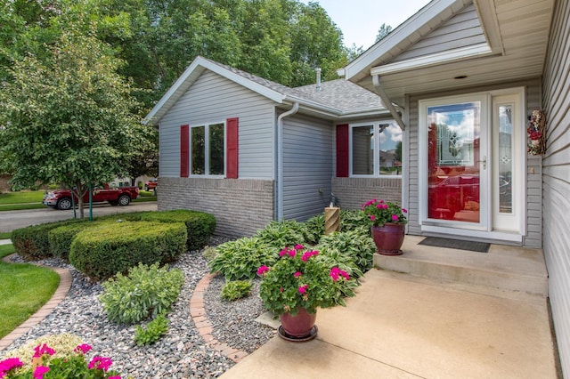 5551 Nancy Ln NW, Rochester, MN 55901 - entrance to property featuring brick siding and a shingled roof
