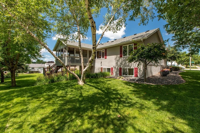 5551 Nancy Ln NW, Rochester, MN 55901 - back of property with a sunroom, a lawn, and stairway