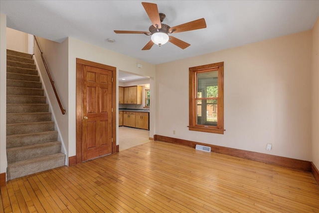 2694 State Road 64, Forest Twp, WI 54013 - unfurnished living room with stairs, light wood finished floors, and a ceiling fan