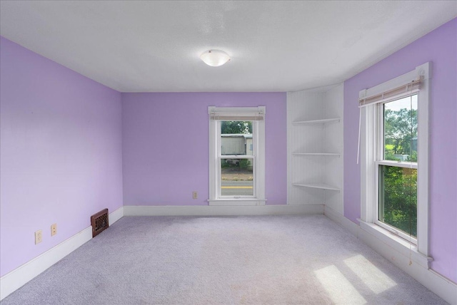 2694 State Road 64, Forest Twp, WI 54013 - unfurnished room featuring healthy amount of natural light, carpet flooring, and built in features