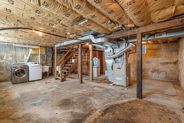 2694 State Road 64, Forest Twp, WI 54013 - unfinished basement featuring washer and dryer, heating unit, and stairway