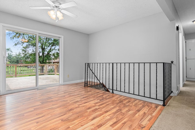 8210 Red Oak Dr, Mounds View, MN 55112 - spare room with a textured ceiling, wood finished floors, and a ceiling fan