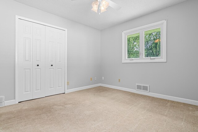 8210 Red Oak Dr, Mounds View, MN 55112 - unfurnished bedroom with carpet floors, a closet, a ceiling fan, and a textured ceiling