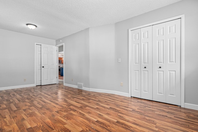 8210 Red Oak Dr, Mounds View, MN 55112 - unfurnished bedroom with wood finished floors and a textured ceiling