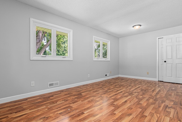 8210 Red Oak Dr, Mounds View, MN 55112 - unfurnished bedroom featuring wood finished floors and a textured ceiling