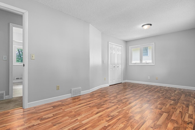 8210 Red Oak Dr, Mounds View, MN 55112 - empty room featuring a textured ceiling and wood finished floors