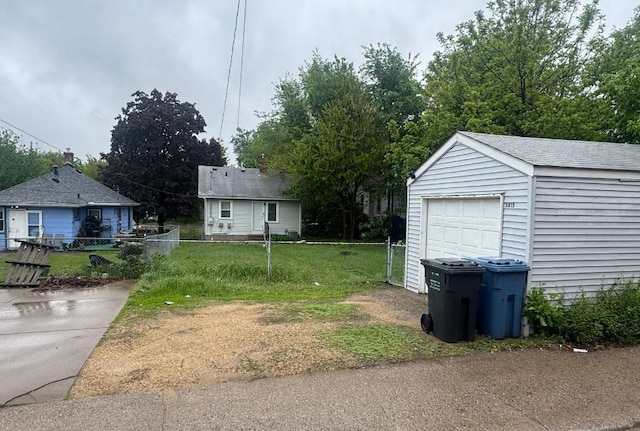 3815 Dupont Ave N, Minneapolis, MN 55412 - view of yard featuring an outdoor structure, driveway, and a garage