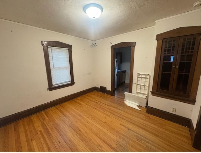 3815 Dupont Ave N, Minneapolis, MN 55412 - spare room with light wood-style flooring and a textured ceiling