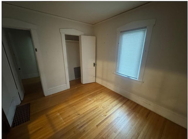 3815 Dupont Ave N, Minneapolis, MN 55412 - unfurnished bedroom featuring wood finished floors and a closet
