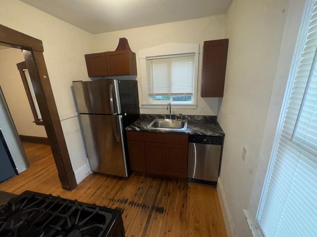3815 Dupont Ave N, Minneapolis, MN 55412 - kitchen featuring stainless steel appliances, wood-type flooring, and dark countertops