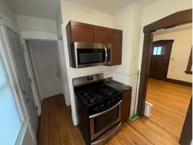 3815 Dupont Ave N, Minneapolis, MN 55412 - kitchen with appliances with stainless steel finishes, light wood-type flooring, and dark countertops