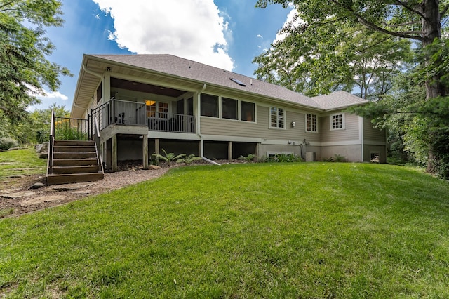 290 Wimbledon Hills Dr SW, Rochester, MN 55902 - rear view of property featuring stairway, a lawn, a wooden deck, roof with shingles, and a sunroom