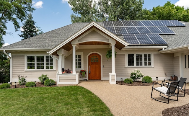 290 Wimbledon Hills Dr SW, Rochester, MN 55902 - view of front facade with a shingled roof, solar panels, and a front lawn