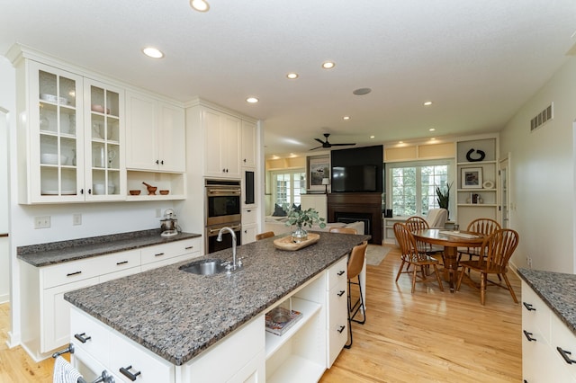 290 Wimbledon Hills Dr SW, Rochester, MN 55902 - kitchen featuring open shelves, stainless steel double oven, a large fireplace, light wood-style floors, and recessed lighting