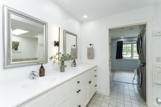 290 Wimbledon Hills Dr SW, Rochester, MN 55902 - bathroom with stacked washer / dryer, double vanity, tile patterned floors, and recessed lighting