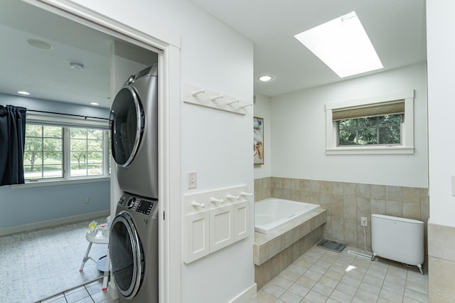 290 Wimbledon Hills Dr SW, Rochester, MN 55902 - bathroom featuring estacked washer and dryer, tile patterned floors, a bath, a skylight, and recessed lighting