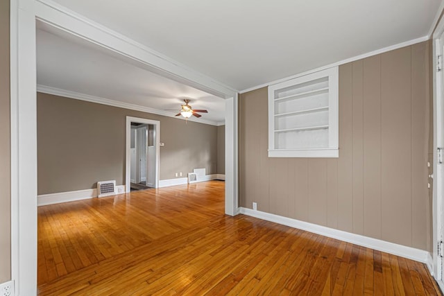 3233 42nd Ave S, Minneapolis, MN 55406 - empty room with hardwood / wood-style floors, built in features, a ceiling fan, and crown molding