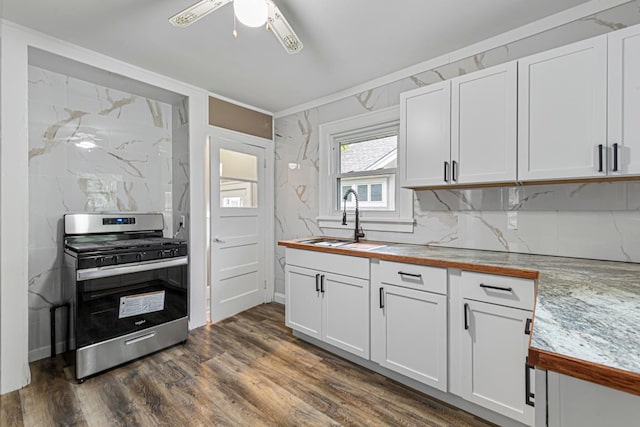 3233 42nd Ave S, Minneapolis, MN 55406 - kitchen with stainless steel gas stove, ceiling fan, ornamental molding, white cabinetry, and dark wood-style flooring