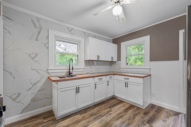 3233 42nd Ave S, Minneapolis, MN 55406 - kitchen with ornamental molding, dark wood-style floors, wood counters, white cabinets, and ceiling fan