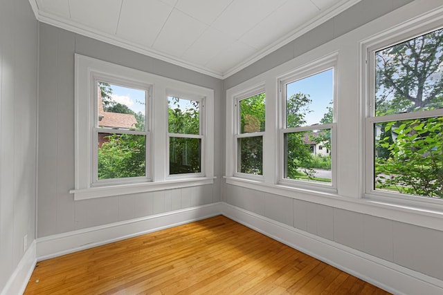 3233 42nd Ave S, Minneapolis, MN 55406 - unfurnished sunroom featuring crown molding, healthy amount of natural light, hardwood / wood-style flooring, and a decorative wall