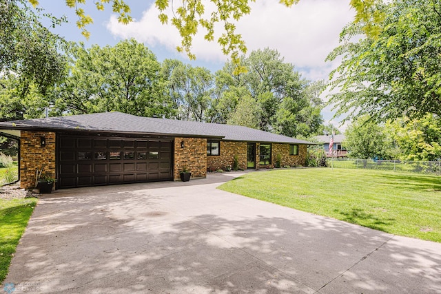 407 6th St NE, Barnesville, MN 56514 - view of front of home with concrete driveway, a garage, brick siding, and a shingled roof