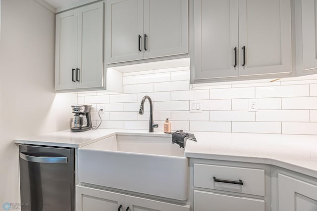 407 6th St NE, Barnesville, MN 56514 - kitchen with stainless steel dishwasher, backsplash, and light countertops