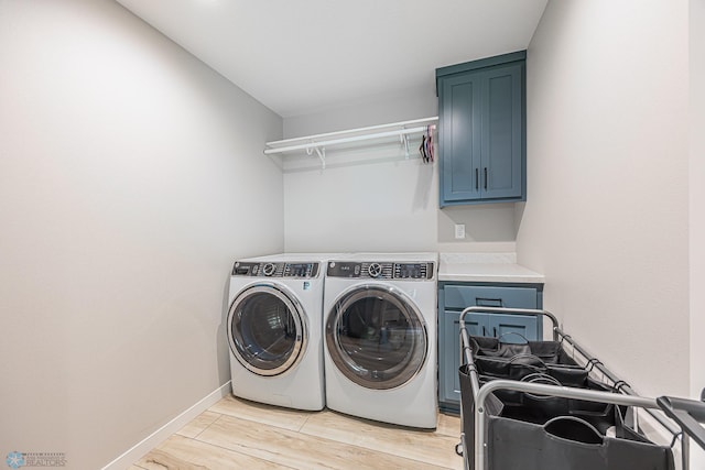 407 6th St NE, Barnesville, MN 56514 - washroom featuring cabinet space, washing machine and dryer, and light wood-style floors