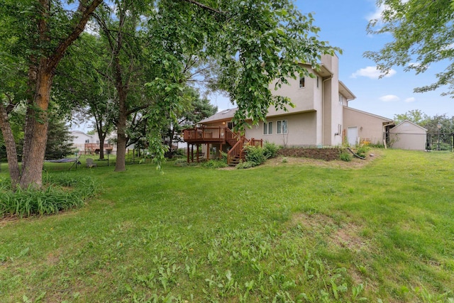 9055 Regent Pkwy, Brooklyn Park, MN 55443 - view of green lawn with stairs, a wooden deck, and a garage
