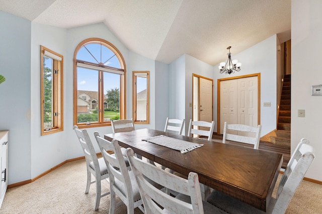 9055 Regent Pkwy, Brooklyn Park, MN 55443 - dining space with vaulted ceiling, a chandelier, stairs, and light carpet