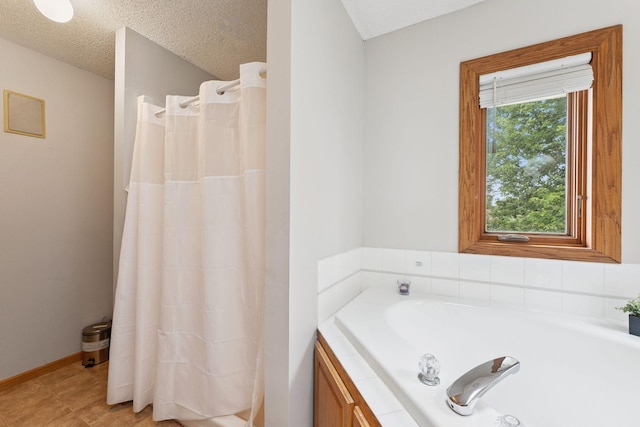 9055 Regent Pkwy, Brooklyn Park, MN 55443 - bathroom featuring a tub to relax in, a textured ceiling, a shower with curtain, and tile patterned floors