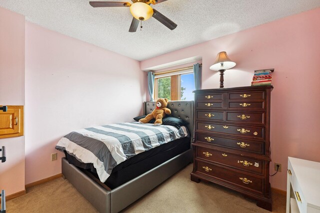 9055 Regent Pkwy, Brooklyn Park, MN 55443 - bedroom with light carpet, a textured ceiling, and a ceiling fan