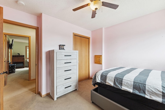 9055 Regent Pkwy, Brooklyn Park, MN 55443 - bedroom with light carpet, a ceiling fan, and a closet