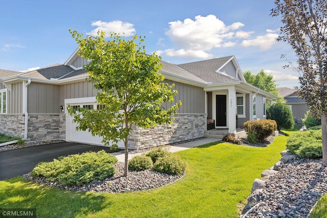 5053 Sunstream Ln, Woodbury, MN 55129 - view of front facade with board and batten siding, stone siding, a garage, roof with shingles, and a front lawn