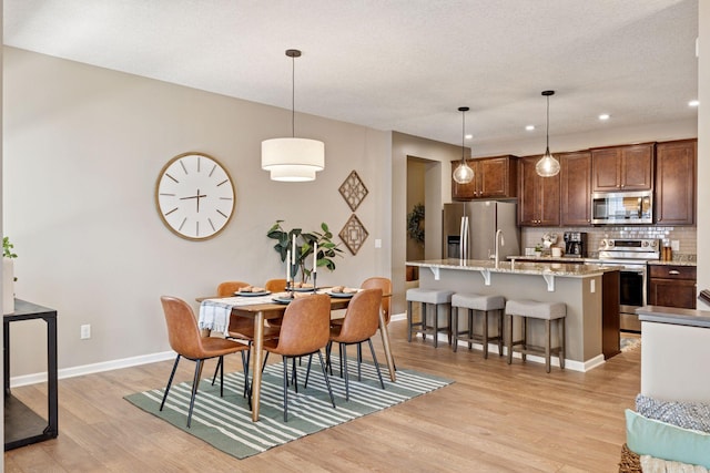 5053 Sunstream Ln, Woodbury, MN 55129 - dining room featuring light wood-style flooring and recessed lighting