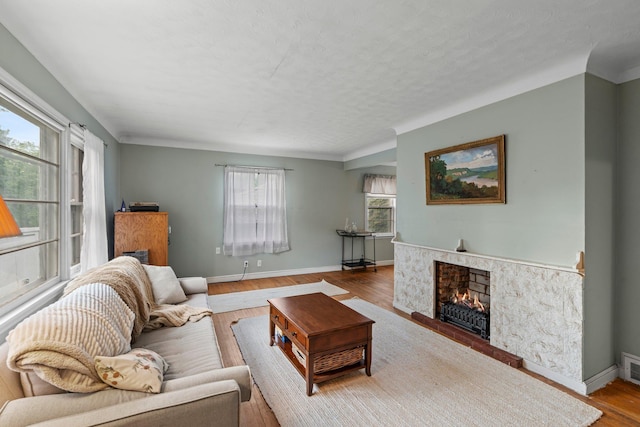 1062 Ohio St, West Saint Paul, MN 55118 - living room featuring wood finished floors, a premium fireplace, and a textured ceiling