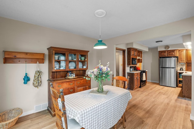 1062 Ohio St, West Saint Paul, MN 55118 - dining space featuring light wood finished floors and baseboards