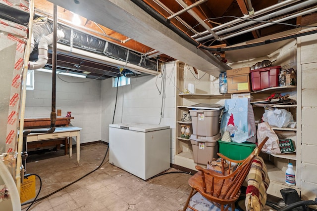 1062 Ohio St, West Saint Paul, MN 55118 - basement with white refrigerator, light flooring, and concrete block wall