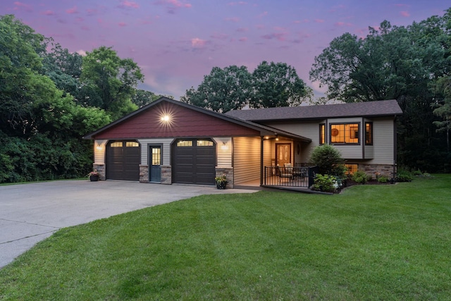 13326 Mallard Dr SE, Becker Twp, MN 55308 - tri-level home featuring a front lawn, an attached garage, concrete driveway, and stone siding