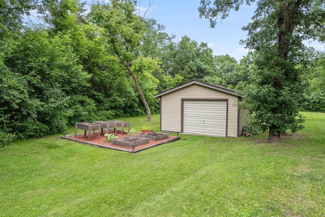 13326 Mallard Dr SE, Becker Twp, MN 55308 - view of grassy yard featuring a vegetable garden, an outbuilding, and a detached garage