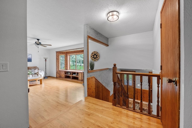13326 Mallard Dr SE, Becker Twp, MN 55308 - hallway with an upstairs landing, wood finished floors, and a textured ceiling