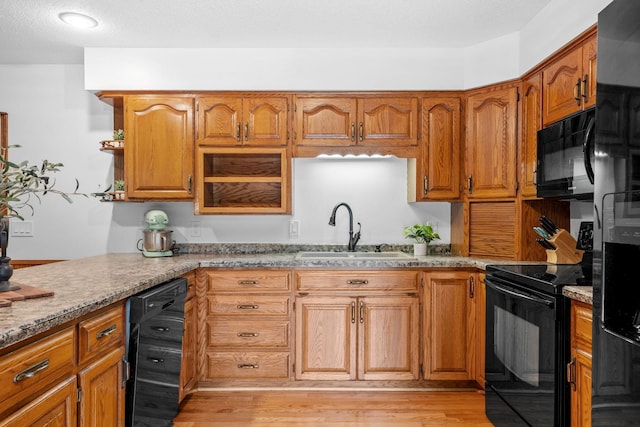 13326 Mallard Dr SE, Becker Twp, MN 55308 - kitchen featuring black appliances, brown cabinets, and wine cooler