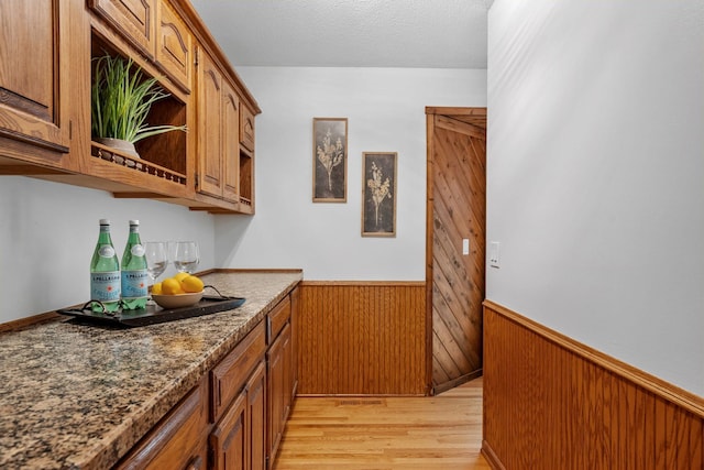 13326 Mallard Dr SE, Becker Twp, MN 55308 - indoor dry bar featuring wainscoting, wooden walls, and light wood-style floors